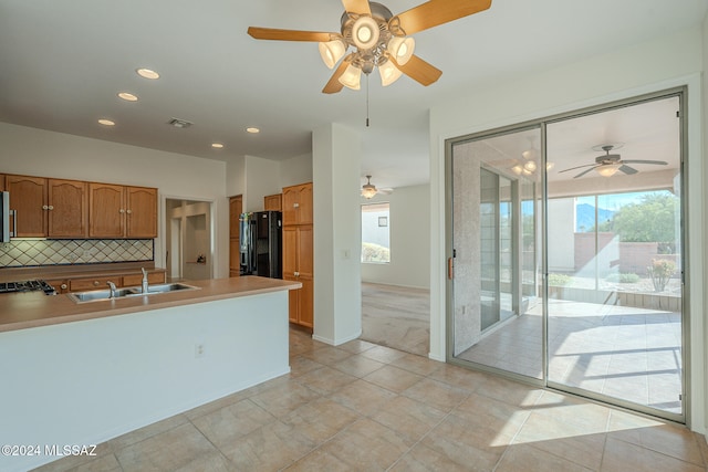 carpeted bedroom with ceiling fan and multiple windows