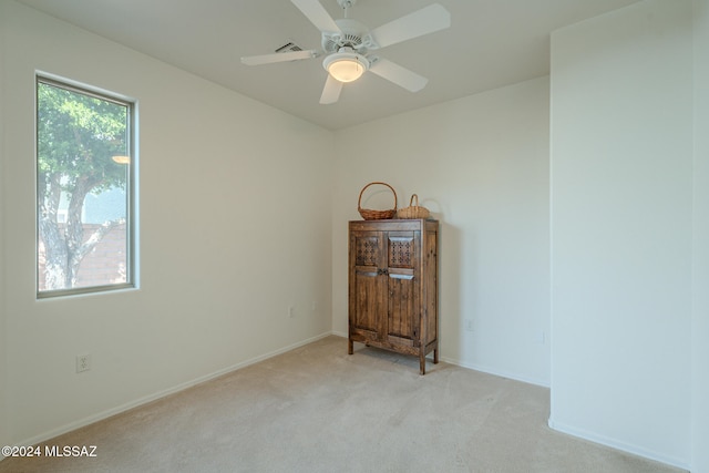 carpeted empty room with ceiling fan