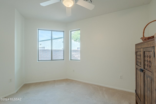 unfurnished bedroom featuring light colored carpet and ceiling fan