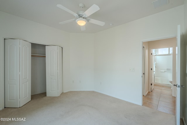 spare room featuring light carpet and ceiling fan