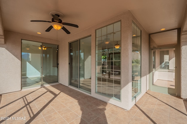 unfurnished sunroom with a mountain view and ceiling fan