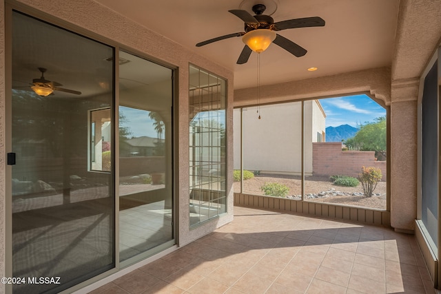 doorway to outside featuring a mountain view and light tile patterned floors