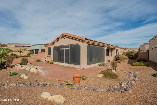 back of house with a patio area and a sunroom