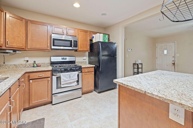 kitchen featuring light stone countertops and stainless steel appliances