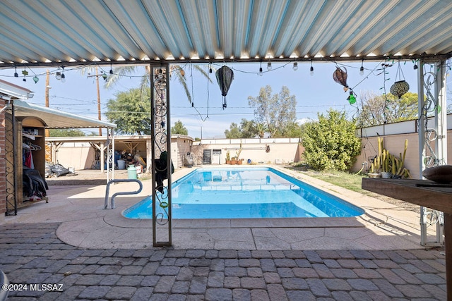 view of swimming pool with a patio area