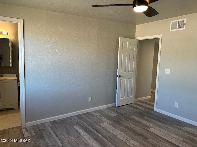 unfurnished room with ceiling fan, sink, and dark hardwood / wood-style floors