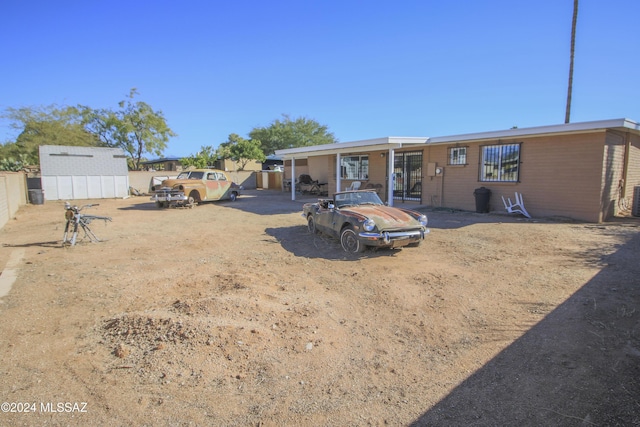 back of house featuring an outbuilding and central AC