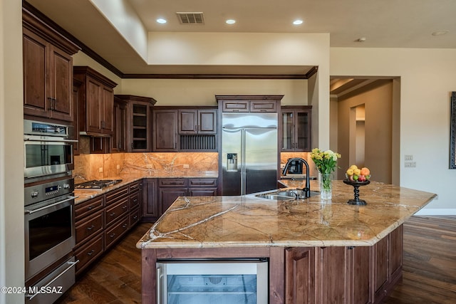 kitchen with beverage cooler, visible vents, glass insert cabinets, stainless steel appliances, and a sink