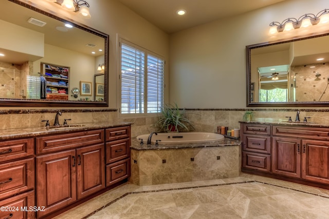 full bath featuring two vanities, visible vents, and a sink