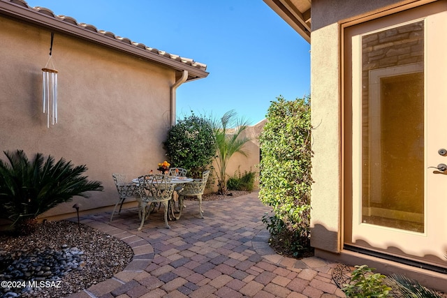 view of patio featuring outdoor dining area and fence