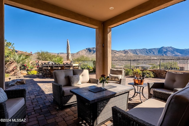 view of patio / terrace with an outdoor hangout area, a fenced backyard, and a mountain view