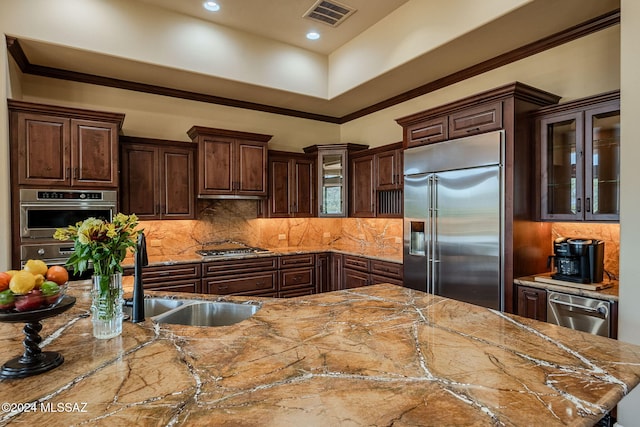 kitchen with stainless steel appliances, visible vents, glass insert cabinets, and light stone countertops