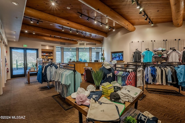 interior space with wooden ceiling, carpet flooring, beam ceiling, and track lighting