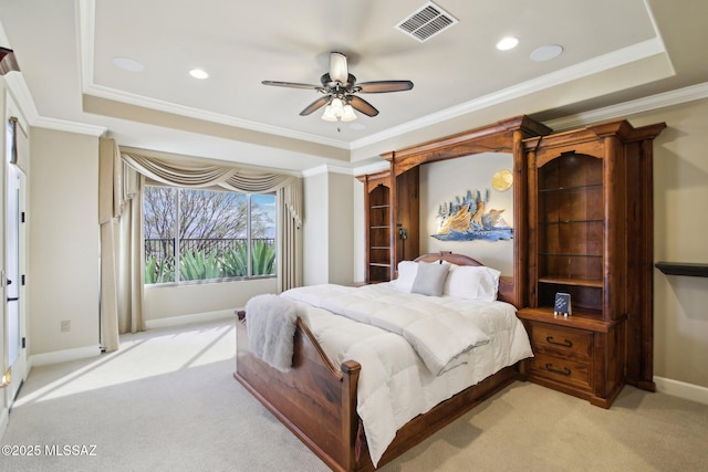 bedroom featuring light carpet, visible vents, baseboards, ornamental molding, and a tray ceiling