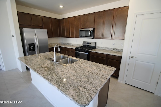 kitchen featuring stainless steel appliances, sink, and a kitchen island with sink