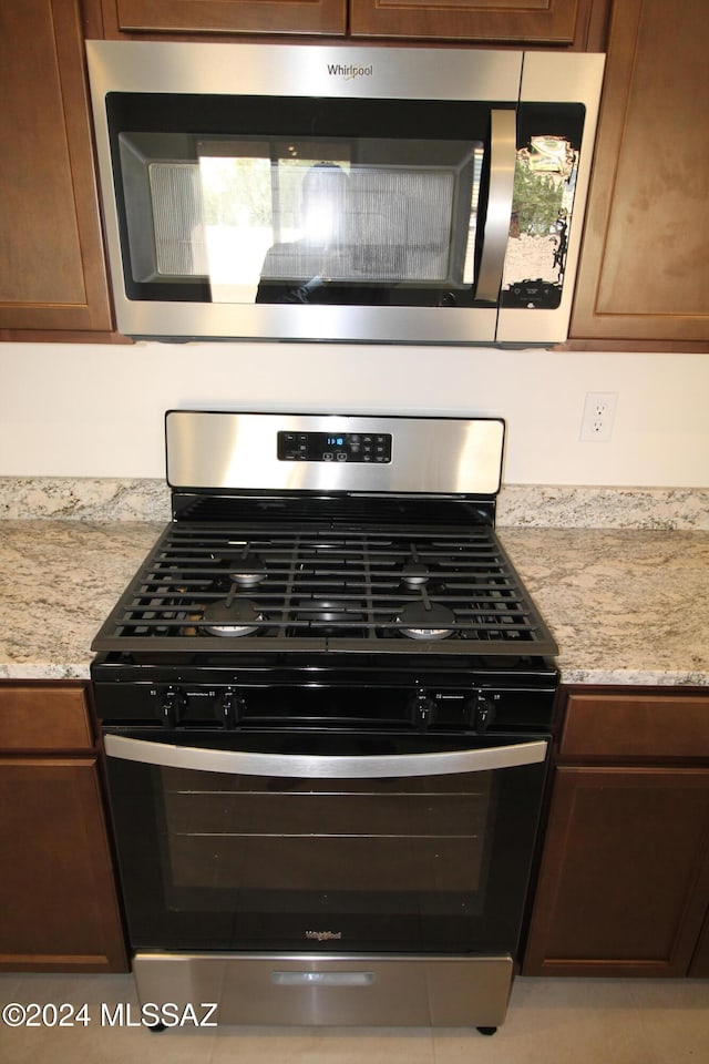 kitchen featuring light stone countertops and appliances with stainless steel finishes