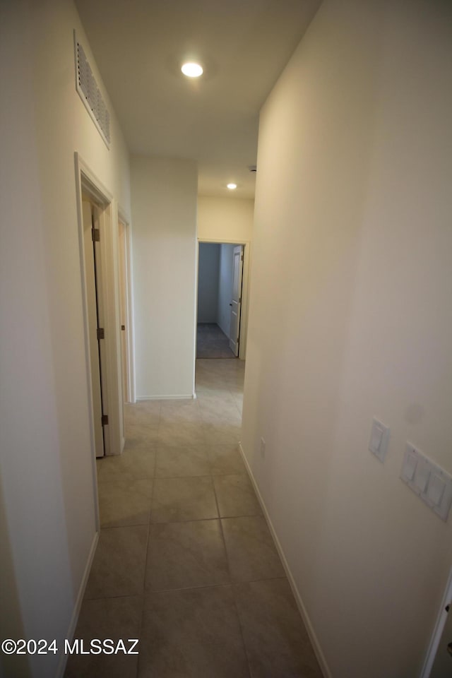 hallway featuring light tile patterned floors