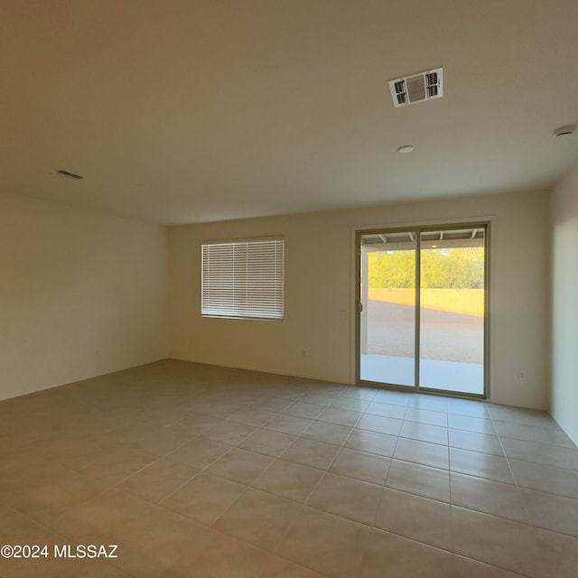 unfurnished room featuring light tile patterned flooring