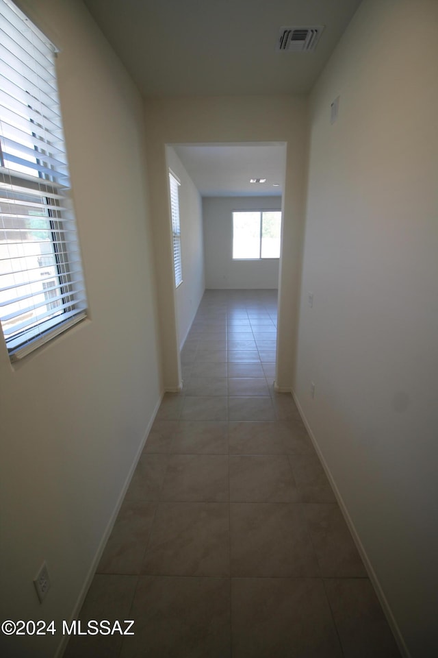 hallway with tile patterned floors