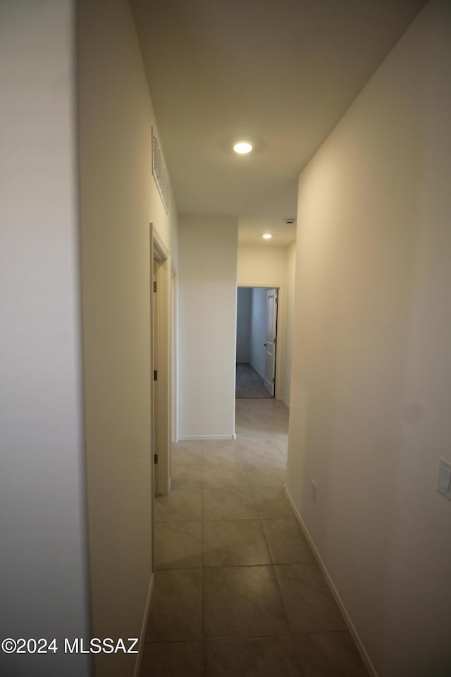 corridor with light tile patterned floors