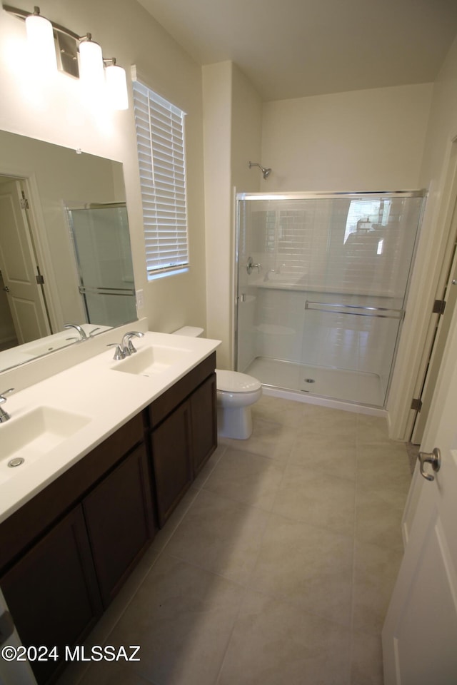 bathroom with walk in shower, tile patterned flooring, vanity, and toilet