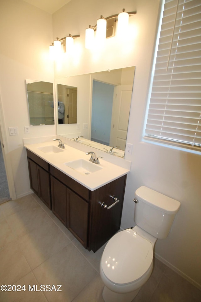 bathroom featuring toilet, vanity, and tile patterned flooring