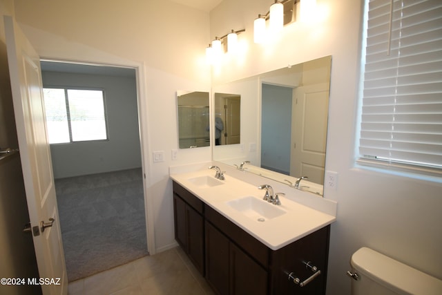 bathroom featuring tile patterned floors, vanity, and toilet