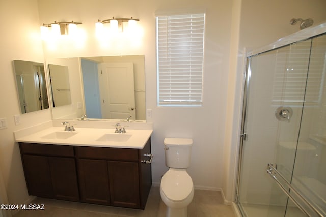 bathroom featuring vanity, toilet, and an enclosed shower