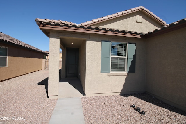 view of exterior entry featuring a patio area