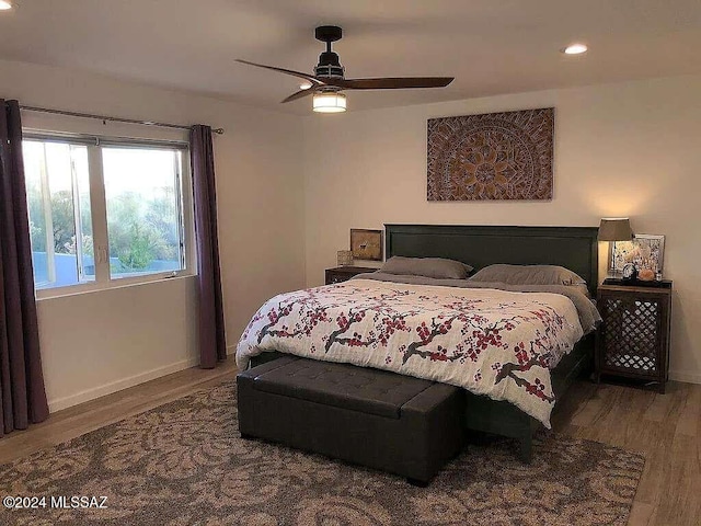 bedroom with hardwood / wood-style floors and ceiling fan