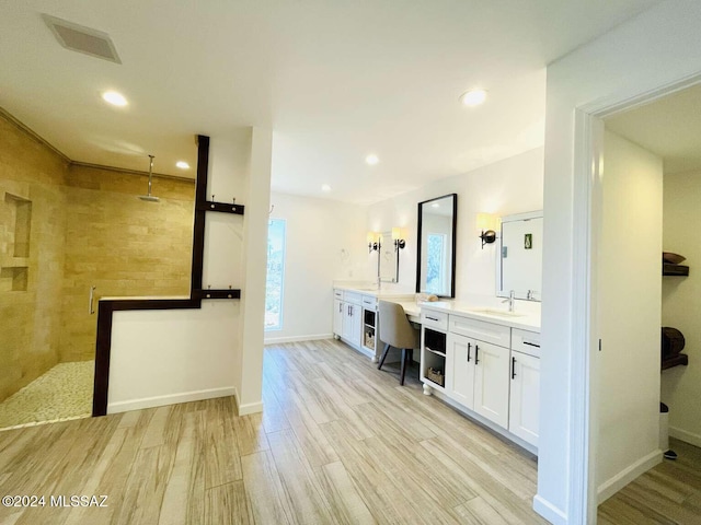 bathroom with vanity, hardwood / wood-style flooring, and walk in shower