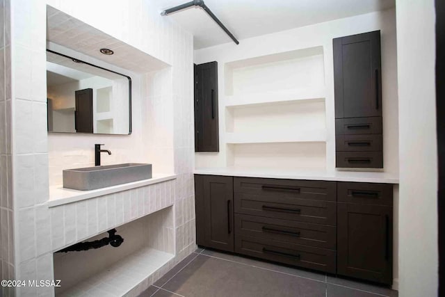 bathroom with tile walls, vanity, and tile patterned flooring