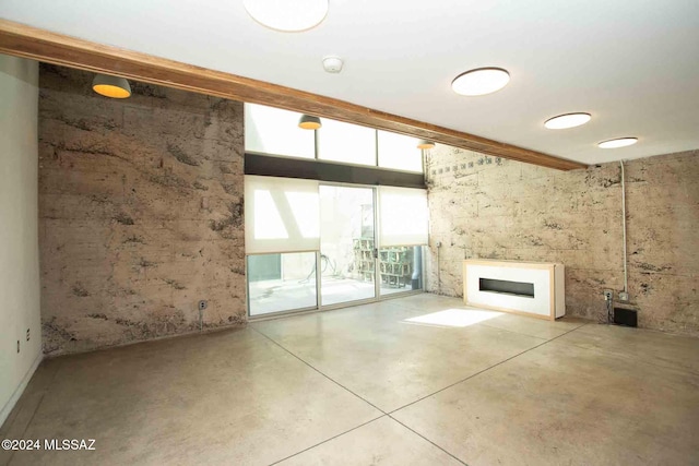 unfurnished living room with concrete floors