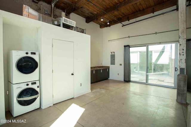 laundry area with stacked washer / drying machine, electric panel, and wooden ceiling