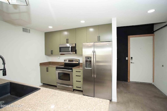 kitchen featuring stainless steel appliances, sink, and green cabinetry