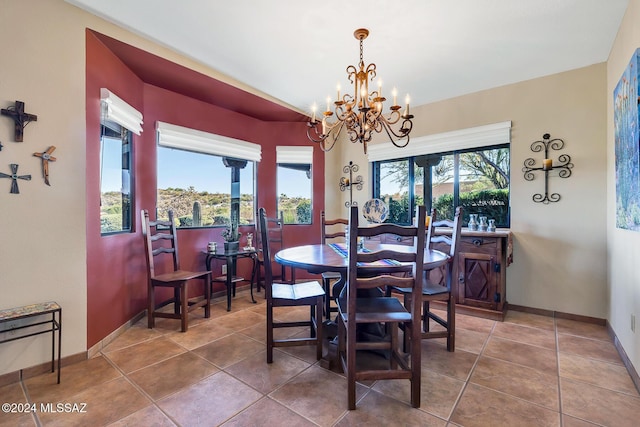 dining room with tile patterned flooring, a wealth of natural light, and a chandelier