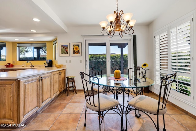 dining room featuring an inviting chandelier, light tile patterned floors, and sink