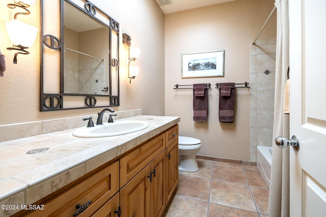 full bathroom with tiled shower / bath, vanity, toilet, and tile patterned flooring