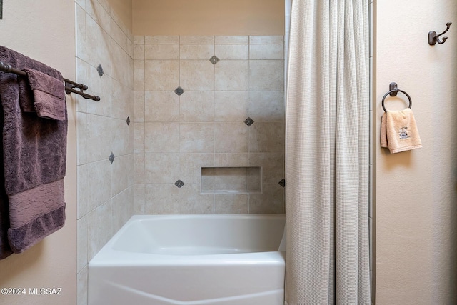 bathroom with shower / bath combo with shower curtain