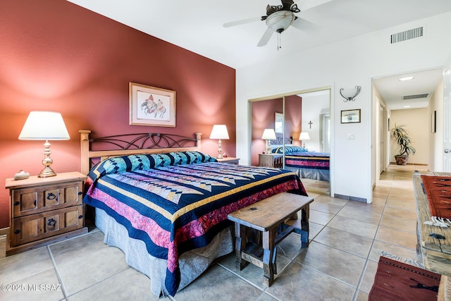 tiled bedroom featuring ceiling fan