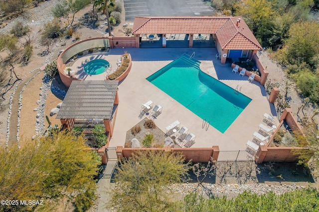 view of pool featuring a hot tub and a patio