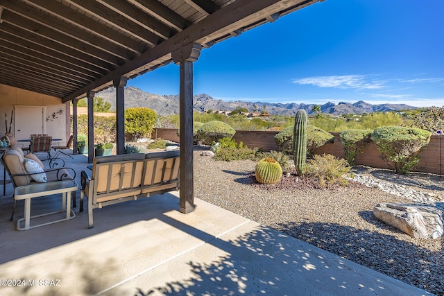 view of patio / terrace with an outdoor hangout area and a mountain view