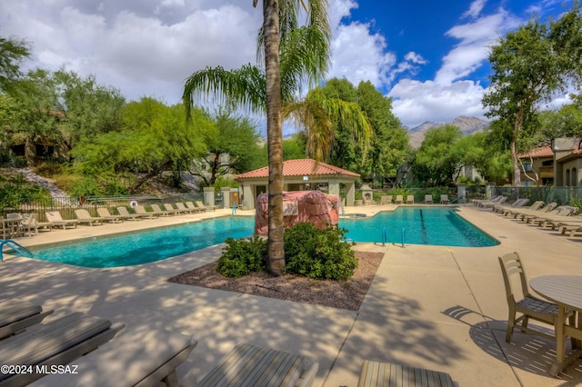 view of pool featuring a mountain view and a patio area