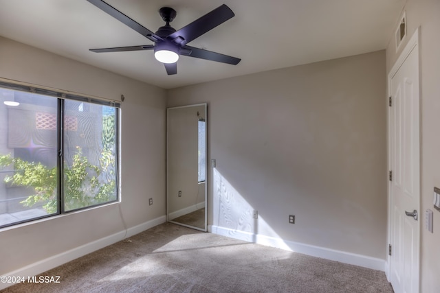 unfurnished bedroom with ceiling fan and light carpet