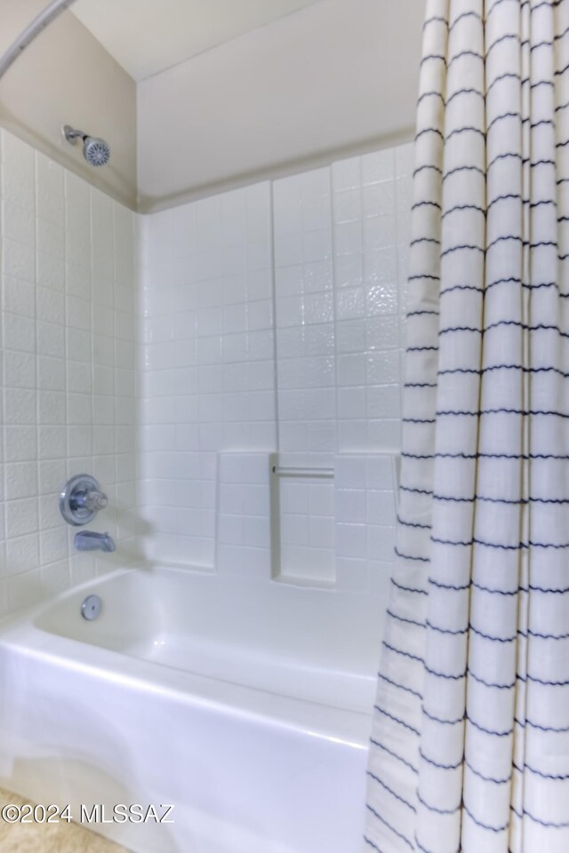 bathroom with shower / bath combo with shower curtain