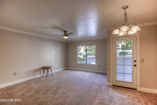 spare room with ornamental molding, ceiling fan with notable chandelier, and carpet floors