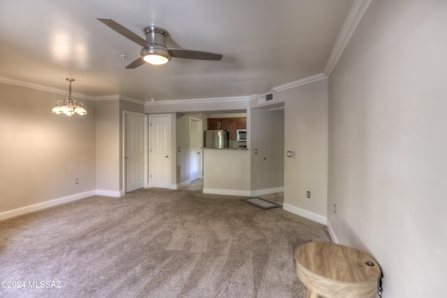 unfurnished living room featuring crown molding, carpet flooring, and ceiling fan with notable chandelier