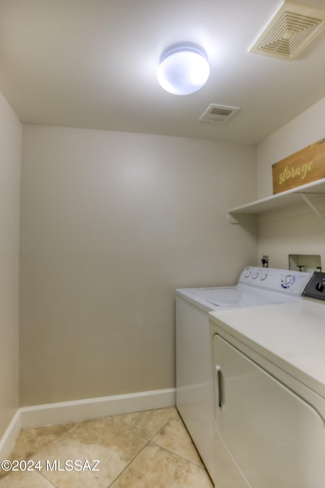 laundry area featuring light tile patterned flooring and separate washer and dryer