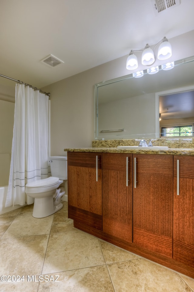 full bathroom with vanity, toilet, shower / bath combo with shower curtain, and tile patterned flooring