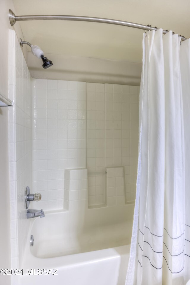 bathroom featuring shower / tub combo with curtain